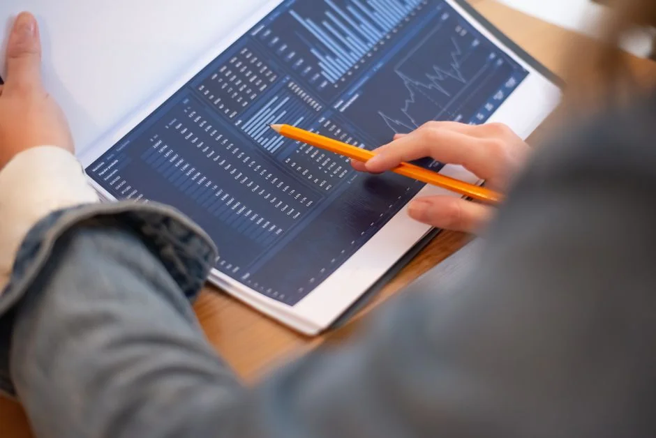 A close-up view of a brand strategy document on a desk surrounded by design artworks.